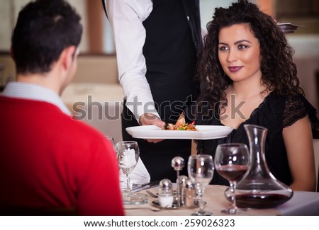 Waiter serving food in a restaurant