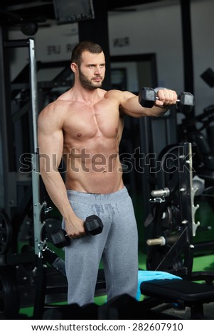 man with weight training equipment on sport in modern gym club