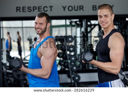 personal trainer helping man to fill the membership form of health club