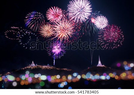 Annual fireworks festival displaying over temple on the mountain. \
Firework sparkling in dark sky celebrating for religious temples on the top of the hills