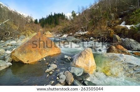 This is transparent river in Caucasus mountains in spring