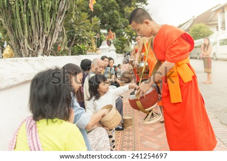 Luang Pra-bang, Lao People\'s Democratic Republic - OCTOBER 19 : Monks ask for alms in the morning at front of Wat Sop Sickharam in Lunag Prabang, Laos on October 19, 2014.