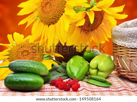 Autumn still life with sunflowers, cucumbers and peppers