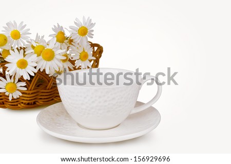still life of white circles and daisies in a basket