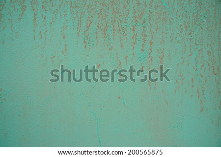 Aged green painted wall background with pink drips. Horizontal