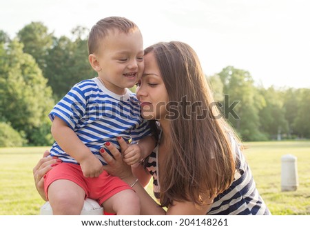 Maternity love. sunset scene in the park. mother and son. copy space right,