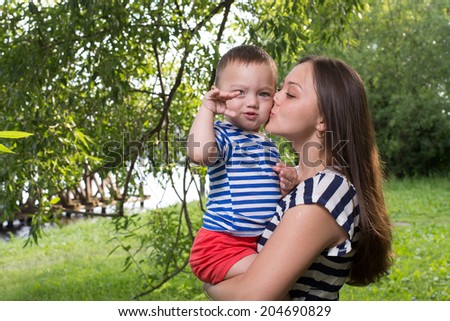 mother kissing son in the park outdoor