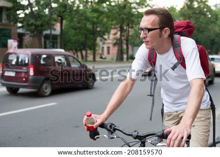 man on bike on the city traffic.