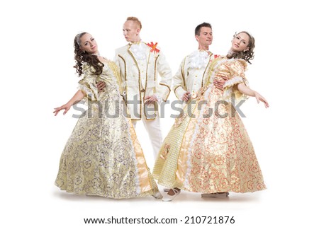 Four young people, two girls and two boys, dressed in historical aristocrat costumes XVIII  century posing in dance figures isolated on white background.