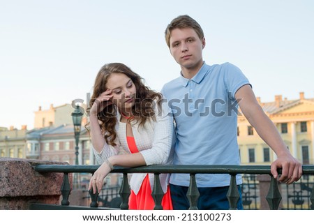 young couple quarrel outdoor on the bridge