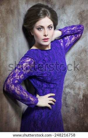 Sexy woman in violet lace dress. Fashion portrait.