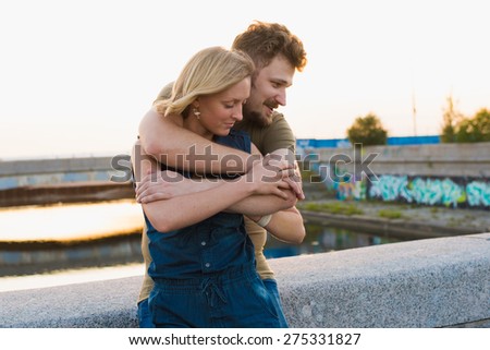 pretty couple embrace outdoor. Handsome bearded man and beautiful slim pretty blonde