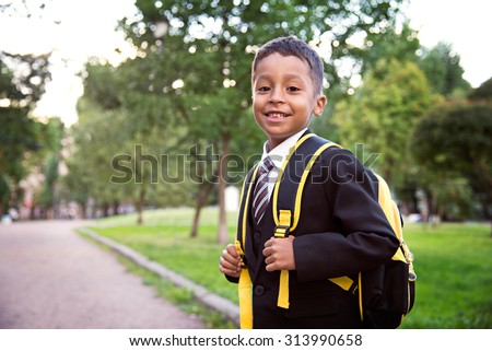 Back to school. Boy from elementary school at the school yard.