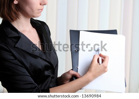The young girl at office shows that that on a paper