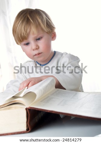 The boy with the big book in hands
