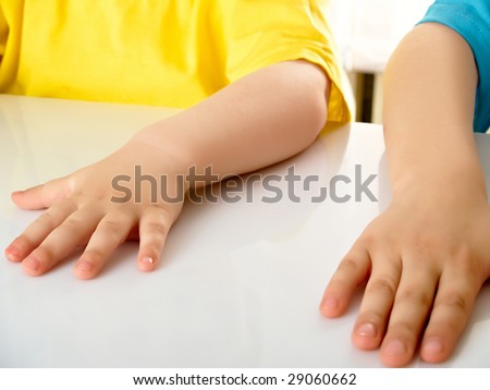Parts of hands of two boys
