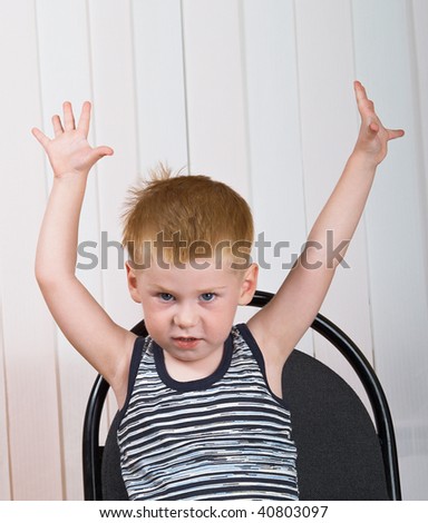 The little boy sits on a chair