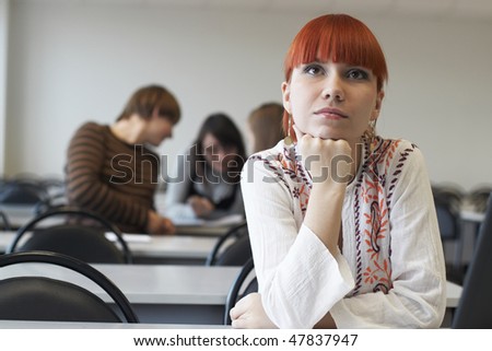 The student in glasses works on notebook