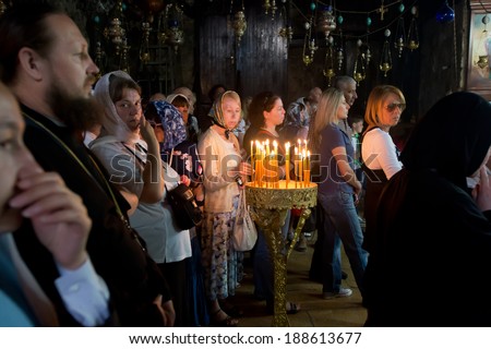 JERUSALEM, ISRAEL - APRIL, 21, 2014 : Christian russian women pray during Easter Sunday  in the dark hall of basilica very close to Garden of Gethsemane in Jerusalem, Israel on April. 21, 2014.