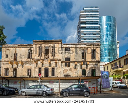 TEL AVIV, ISRAEL - DECEMBER 18, 2014 : Renovation of old historic building over new skyscrapers  in Tel Aviv, Israel on December 18, 2014.