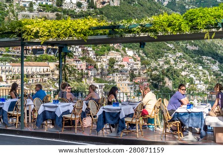 POSITANO, ITALY - MAY 06, 2015 : Unidentified people at restaurant, looking to Positano, Amalfi Coast, Italy.
