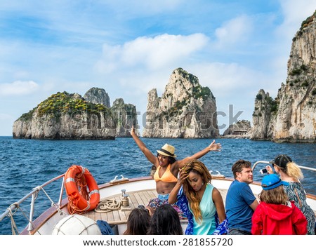 CAPRI, ITALY - MAY 08, 2015 : Unknown tourists on cruise ship round the isle of Capri, Italy.