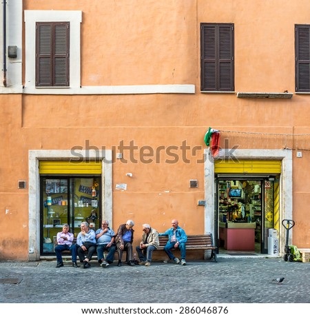 ROME, ITALY - MAY 05, 2015 : Unidentified jewish people are sitting on the bench in Jewish quarter of Rome, Italy.