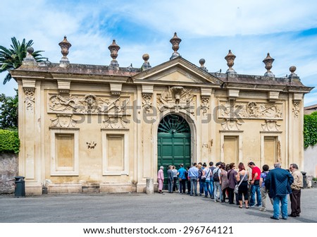 ROME, ITALY-JUNE4, 2015: Unidentified people are waiting to look through keyhole in door at Aventine Hill in Rome, Italy. This is the only place to see three countries at once:Vatican, Italy and Malta