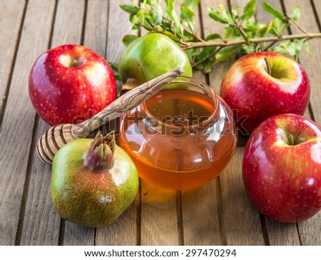 Honey, apples and pomegranates on wood deck  for Rosh Hashana celebration