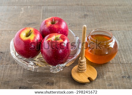 Honey and  apples  on wood deck for Rosh Hashana  celebration.