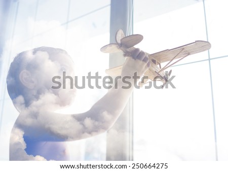 Portrait of child with airplane traveling toy in double exposure