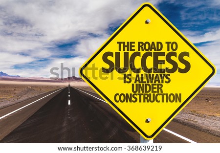 The Road to Success is Always Under Construction sign on desert road