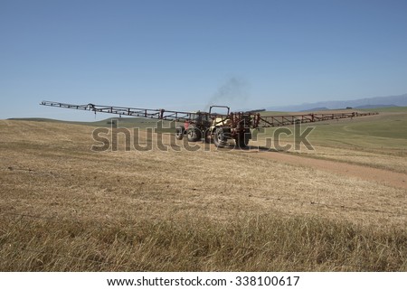 Farm tractor and crop sprayer in the Swartland region of South Africa