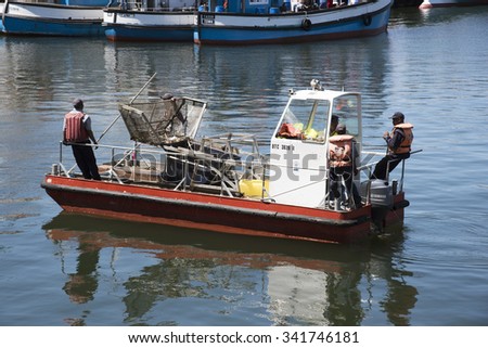 CAPE TOWN HARBOUR CLEAN UP BOAT - OCTOBER 2015 - Garbage clearing boat collecting rubbish from Cape Town harbour South Africa