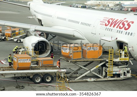 AIRCRAFT LOADING CONTAINER BINS INTO THE HOLD AT JFK NEW YORK - CIRCA 2015 - Cargo Containers being stowed in the hold of a Swiss Airbus A330 aircraft at JFK International airport NY USA