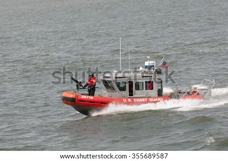 AMERICAN COAST GUARD VESSEL UNDERWAY NEW YORK - CIRCA  2013 - US Coast Guard patrol boat with officer manning gun on the bow patrolling on New York Harbor NY USA