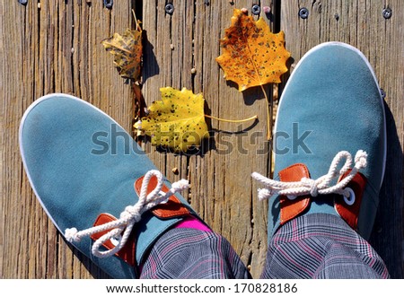 Men blue casual shoes on wooden path