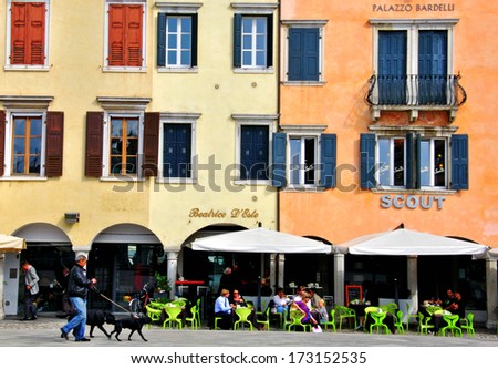 UDINE, ITALY - OCTOBER 3: People sitting in cafe on the main square of Udine on October 3, 2012. The Rialto Bridge is one of the four bridges spanning the Grand Canal in Venice, Italy.