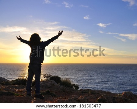 Child silhouette Hugging the sun on sunset