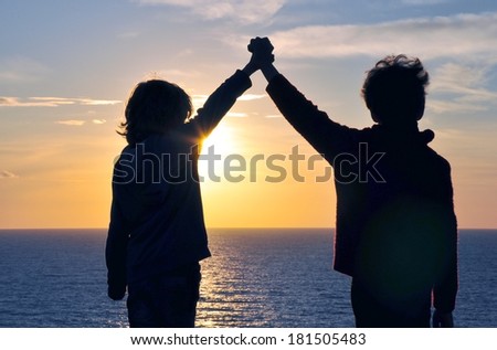 Friendship and hands in the air on sunset