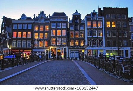 AMSTERDAM, NETHERLANDS - MARCH 25: Typical street of Amsterdam city centre at night on March 25, 2012. Amsterdam is a capital and the largest city of Netherlands.