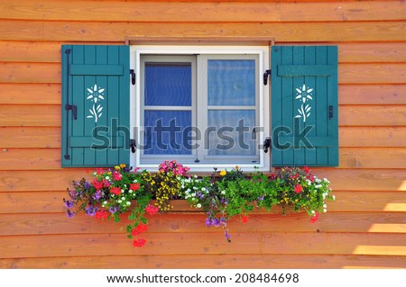 Window with flowers in italian house, Dolomites Alps