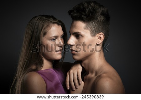 Portrait of beauty young couple against dark grey background