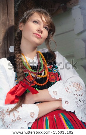 Young woman in Mazovia national costume, a Polish folk costume, looking away