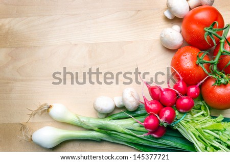 Wooden cutting board with vegetables