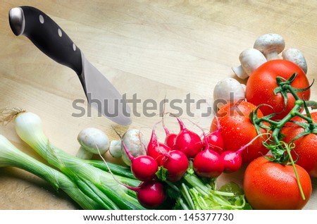 Wooden cutting board with vegetables