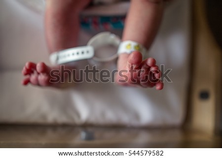 Newborn baby feet and toes in bassinet in hospital