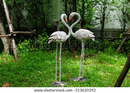 statue bird garden background wall two animal flamingo shot color green