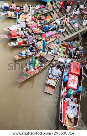 Samutsakorn, Thailand - July 14, 2013: Village and market along a river with Longtail boat with food and souvenir for sale in  Amphawa floating market.