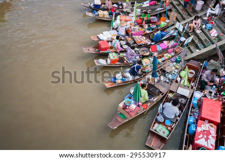 Samutsakorn, Thailand - July 14, 2013: Village and market along a river with Longtail boat with food and souvenir for sale in  Amphawa floating market.